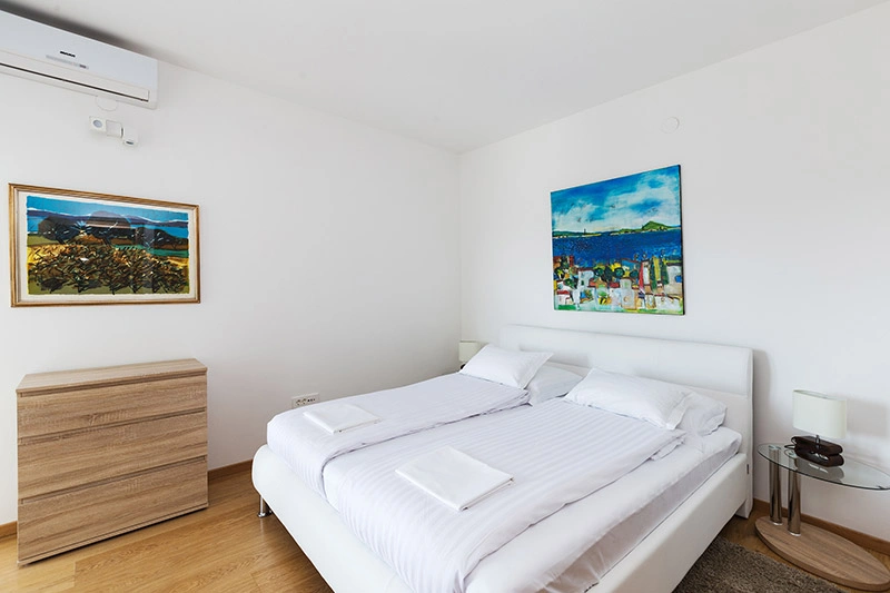 Bedroom with balcony doors open to the sea